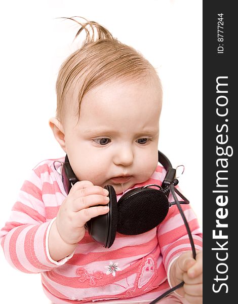 Baby with headphones on white