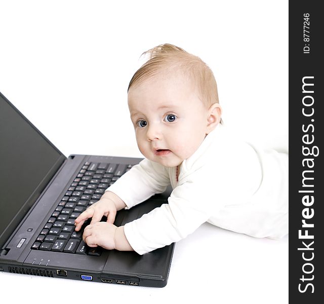 Little baby with laptop on white