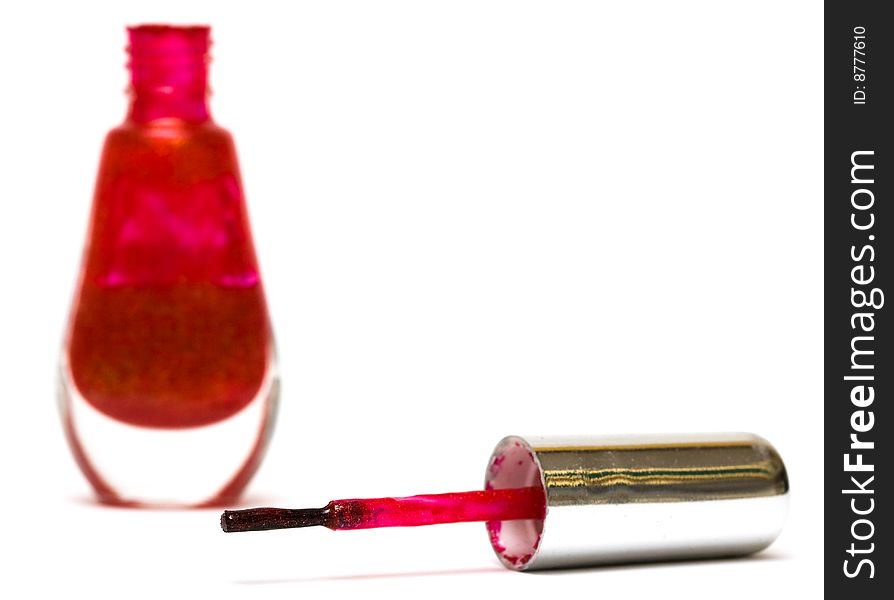 Brush of red nail polish on white background