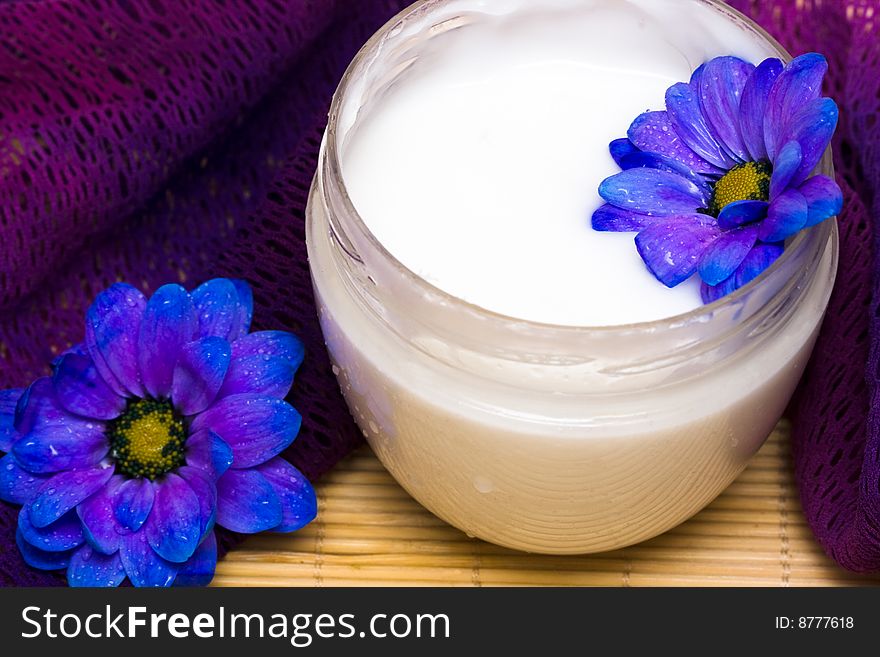 Cream, towel with blue flower. Cream, towel with blue flower