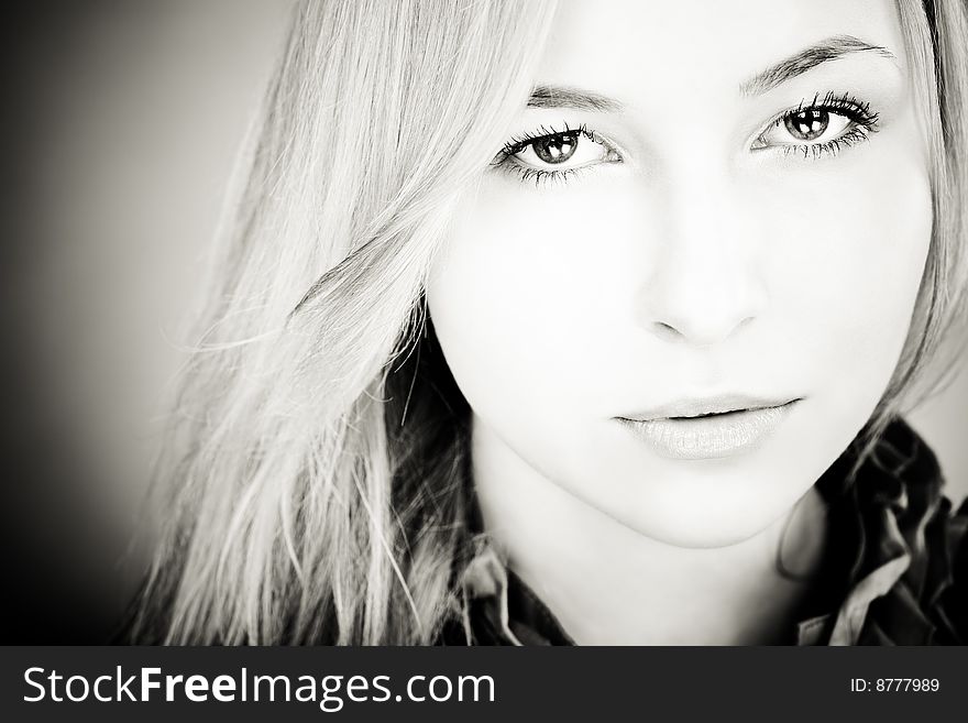 Head and shoulders portrait of young blond girl with beautiful eyes. Woman looking to camera, focus on eyes. Head and shoulders portrait of young blond girl with beautiful eyes. Woman looking to camera, focus on eyes.
