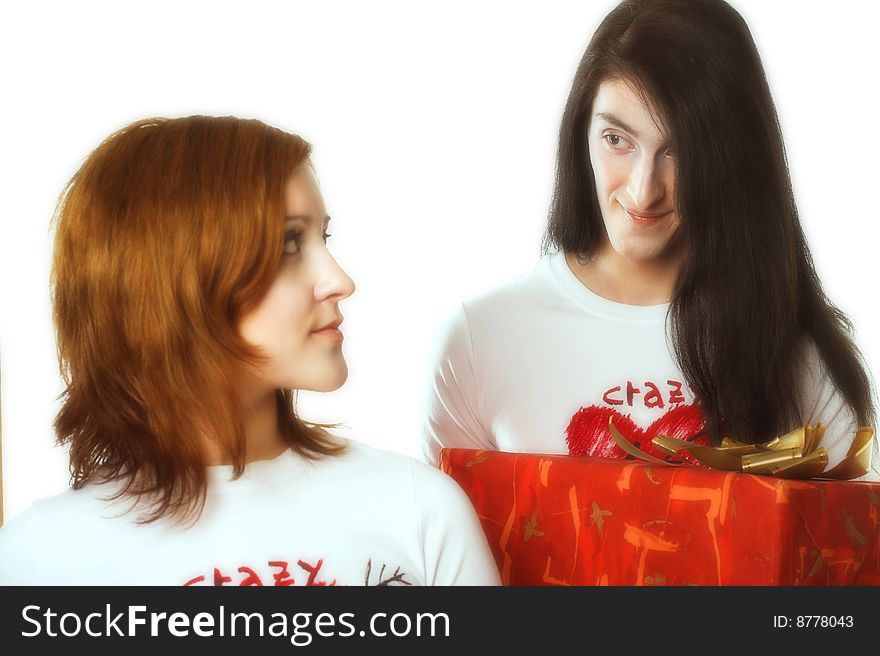 Young happy couple with big red present box.