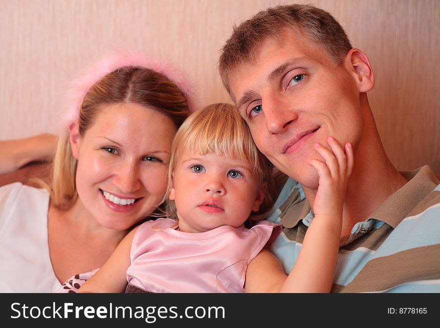 Happy family with little girl in home