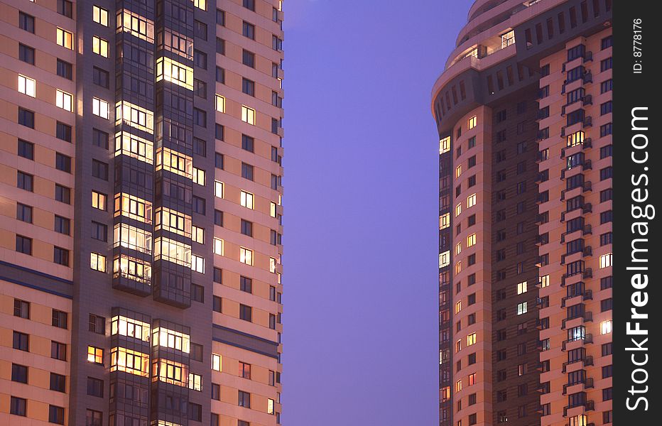 Two apartment houses in evening, fragment