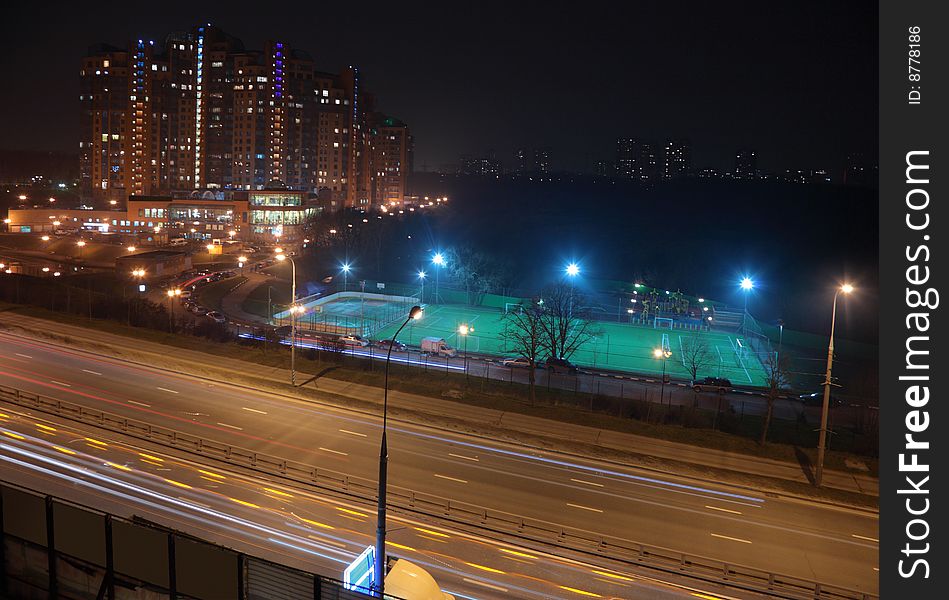 Night street, stadium, houses witn lights