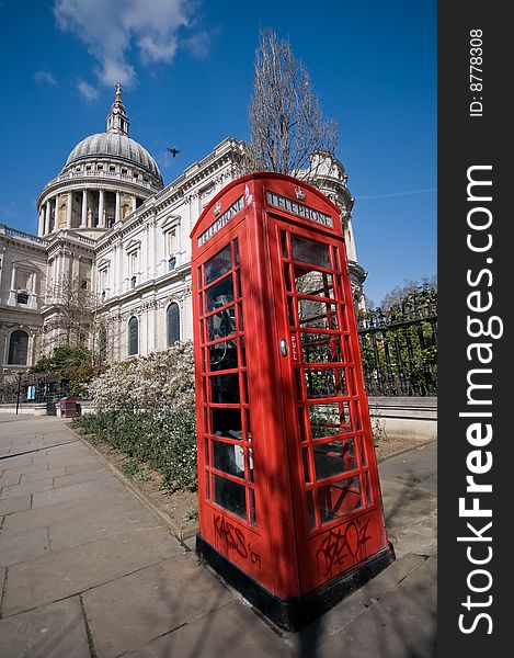 Photograph of Saint Pauls with a traditional red english phonebooth in the foreground, with a bird caught mid flight. Photograph of Saint Pauls with a traditional red english phonebooth in the foreground, with a bird caught mid flight.