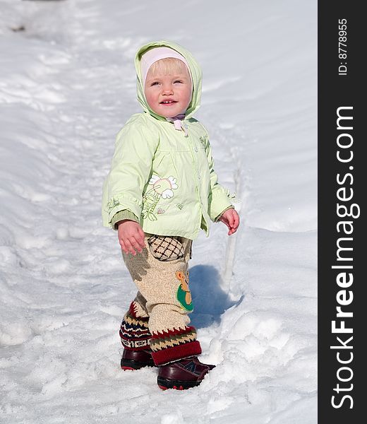Cute child stands on snow