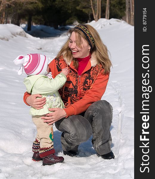 Child with mother together in woods at springtime