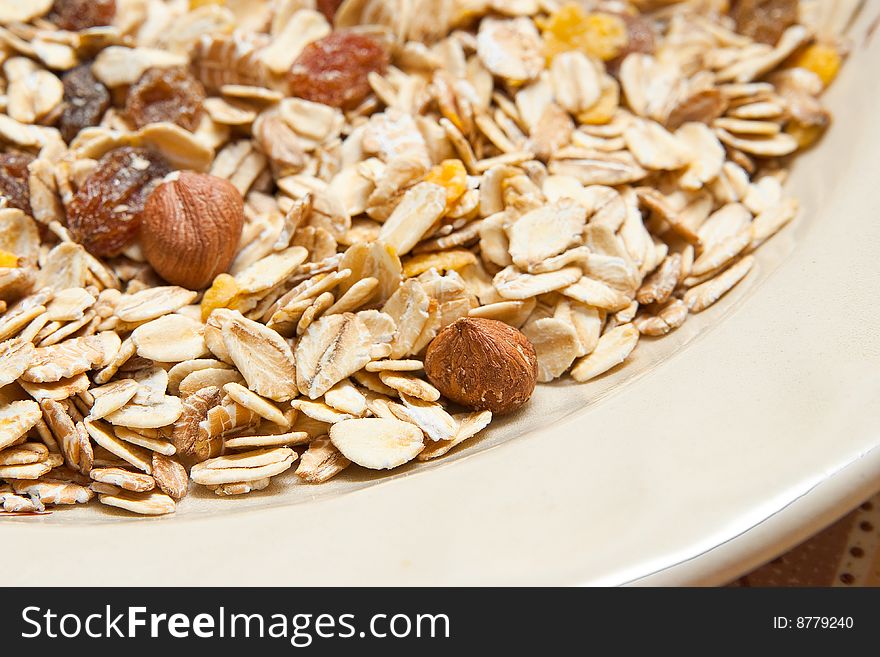 A background image of healthy cereal mixed with dark raisins and peanuts. A background image of healthy cereal mixed with dark raisins and peanuts
