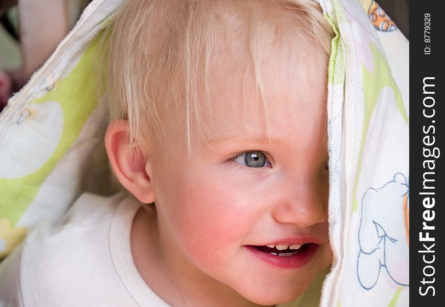 Cute child looks from blankets