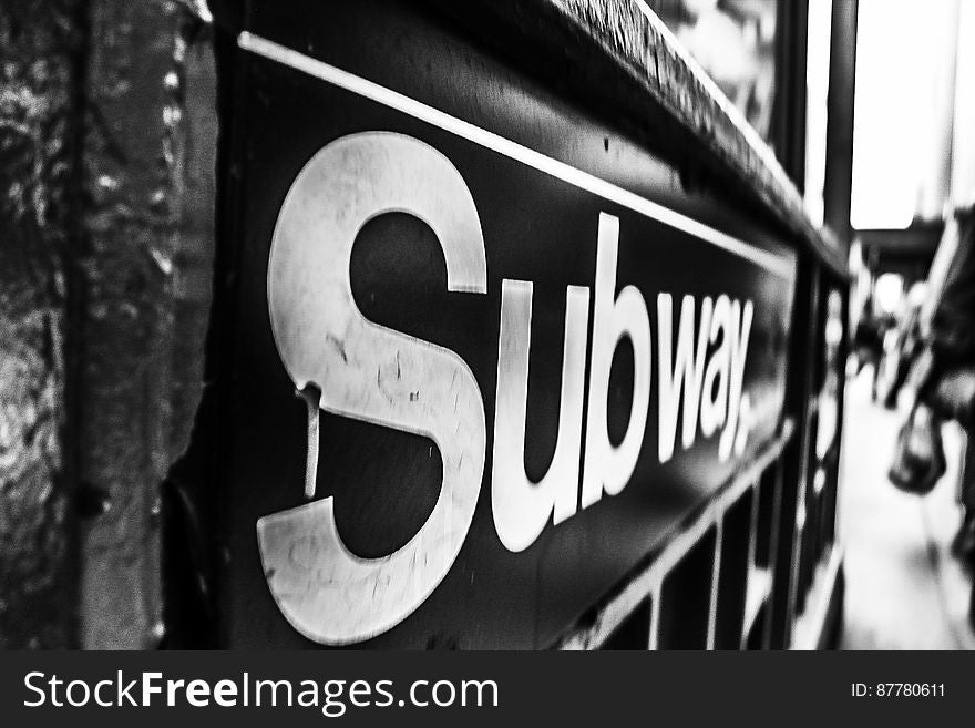 A black and white image of a subway sign.