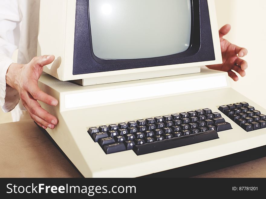 A person holding a classic Commodore PET personal computer.