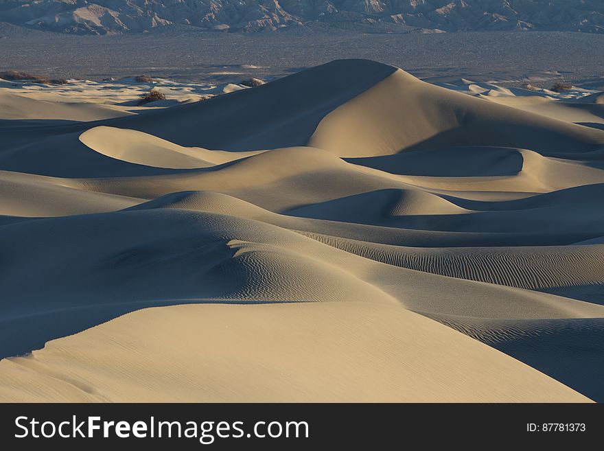 A desert landscape with sand dunes.