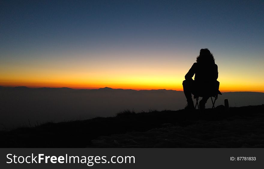 Silhouette Of Person On Mountain At Sunset