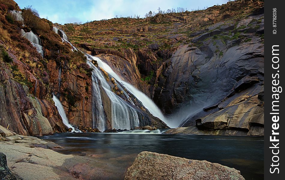 Waterfall Over Rocky Hillside