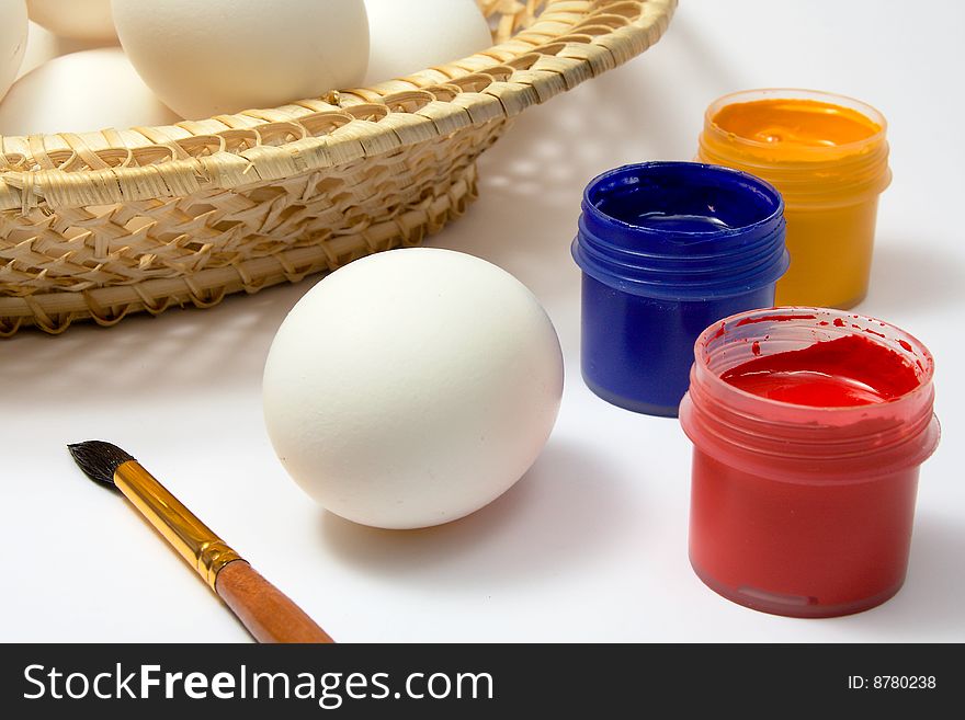 Eggs and paints, preparation for easter on white