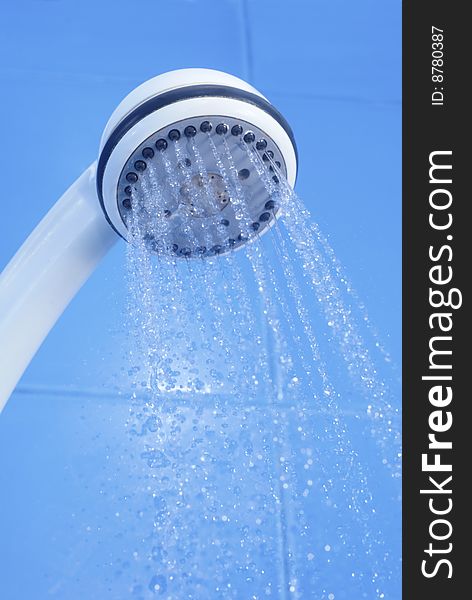 Flozen drops of water from white shower on blue tiled background. Flozen drops of water from white shower on blue tiled background