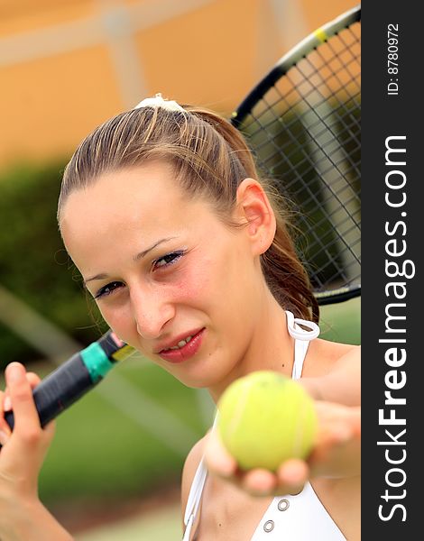 Woman in white bikini playing tennis outdoor