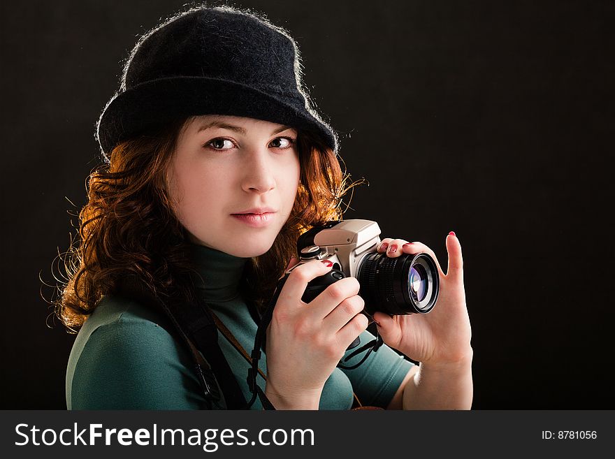 Girl holding a photo on black background. Girl holding a photo on black background
