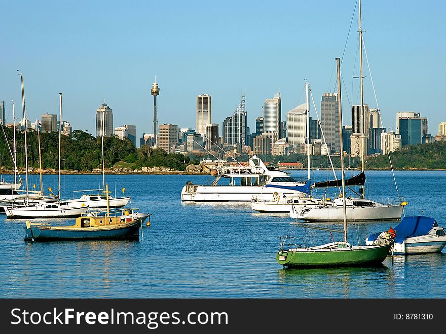 A view down Sydney harbor with yachts lit by dawn light. A view down Sydney harbor with yachts lit by dawn light