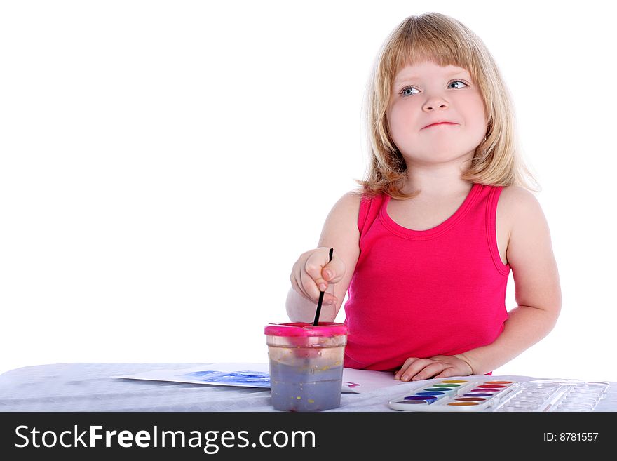 Girl with paint beside table isolated on white