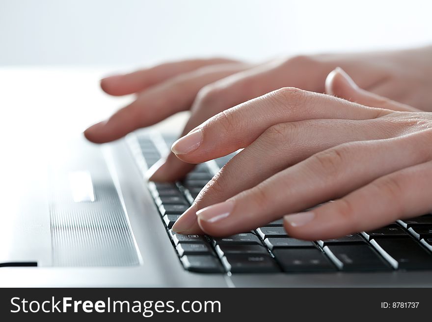Close-up of female fingers typing a business document on the laptop. Close-up of female fingers typing a business document on the laptop