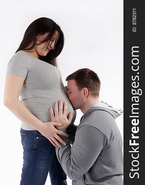 Man kissing pregnant woman in to a stomach. Man kissing pregnant woman in to a stomach