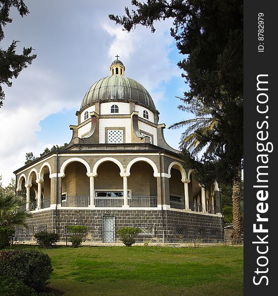 Showy church with a colonnade in monastic to a garden