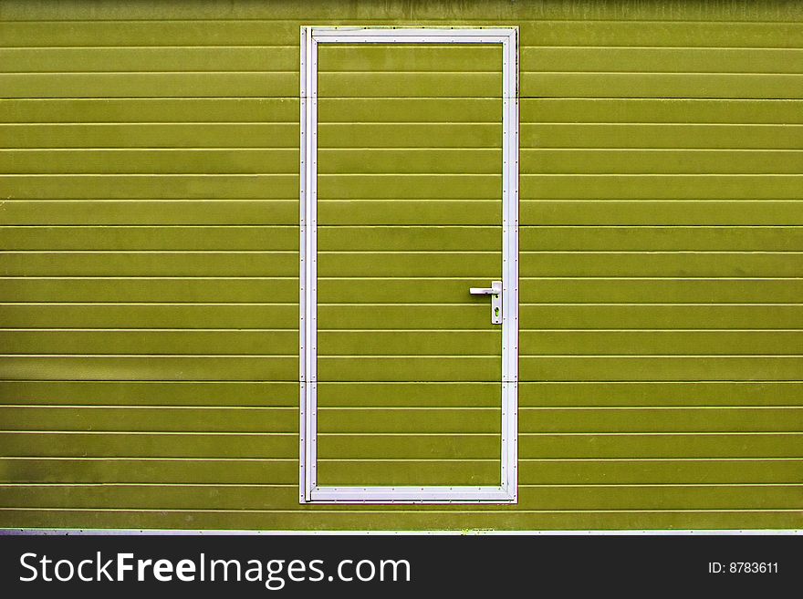 Simple metal door in yellow wall. Simple metal door in yellow wall