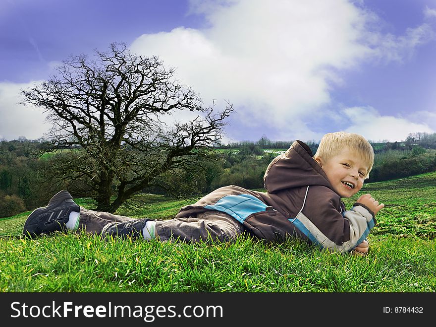 A three year old boy happily enjoys the great outdoors,. A three year old boy happily enjoys the great outdoors,