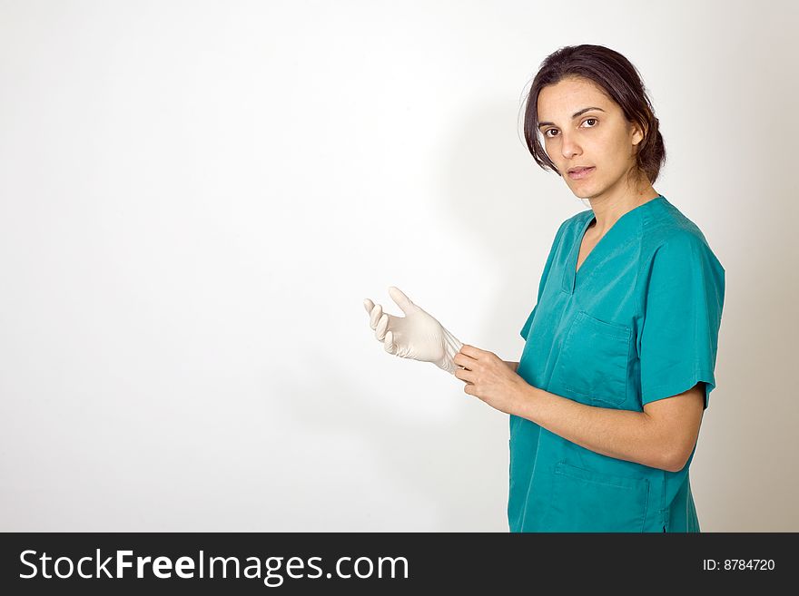 Young nurse stanging before white background