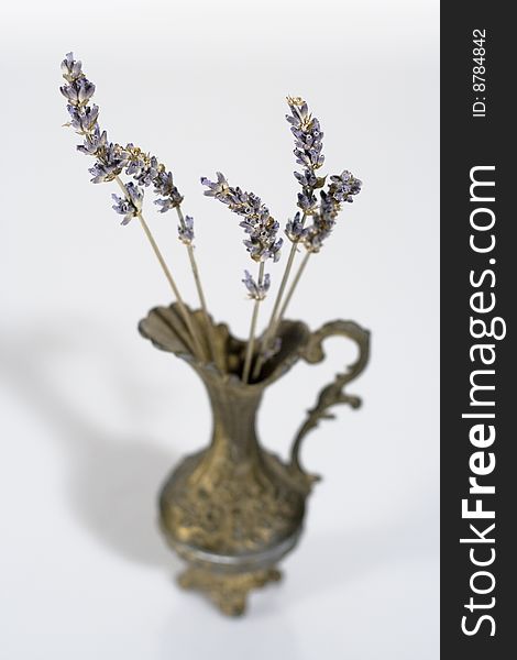 Aromatic lavender stems in a vintage vase with shadow and blur
