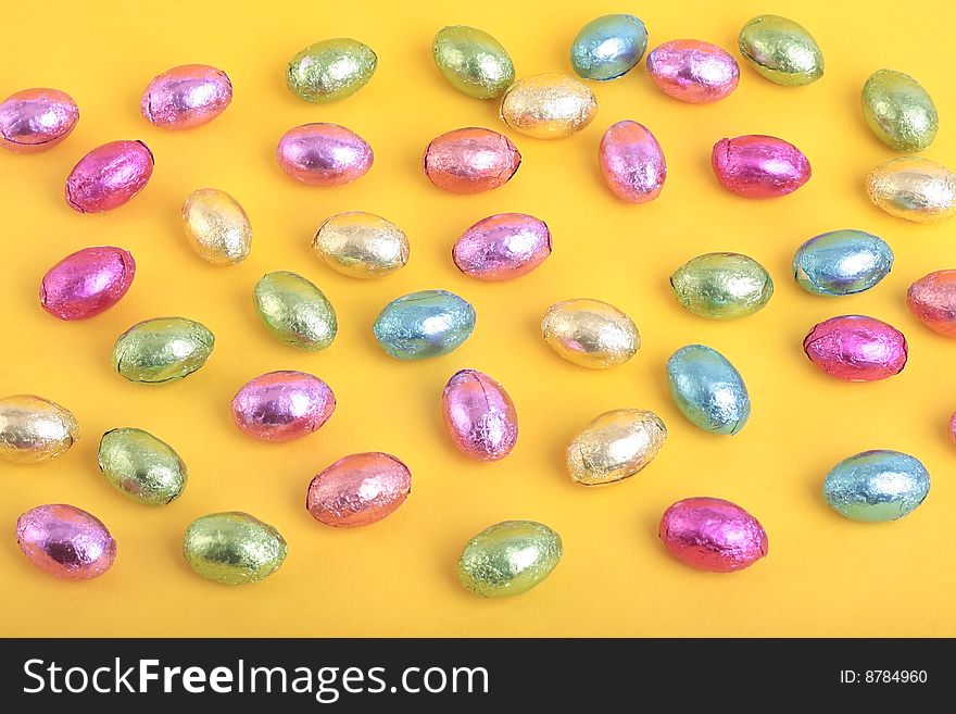 Easter eggs over yellow