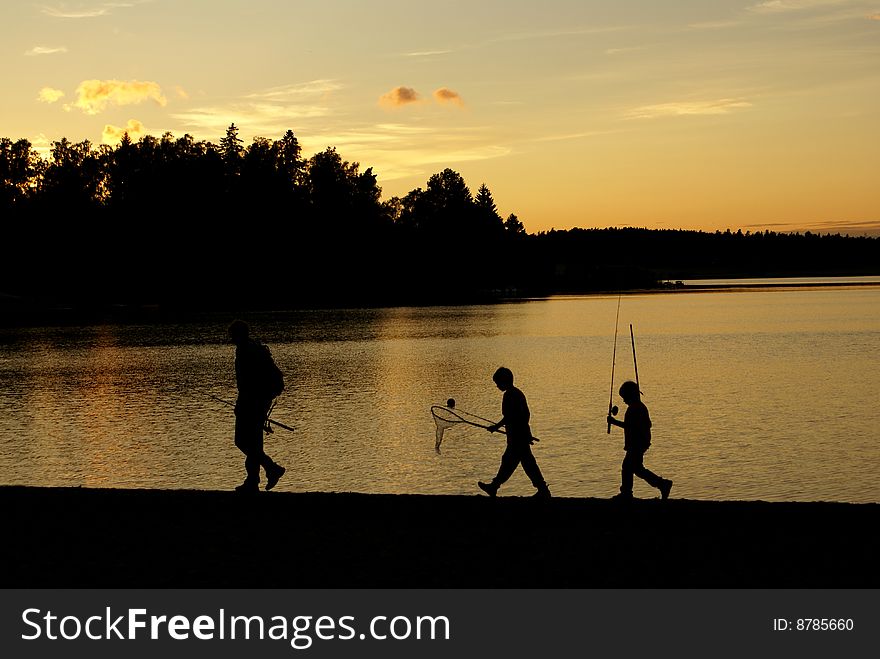 A group of three returning after fishing. A group of three returning after fishing.
