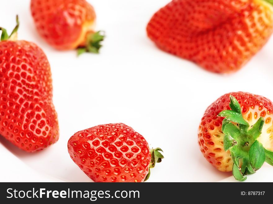 The strawberry is isolated on a white background, close up.