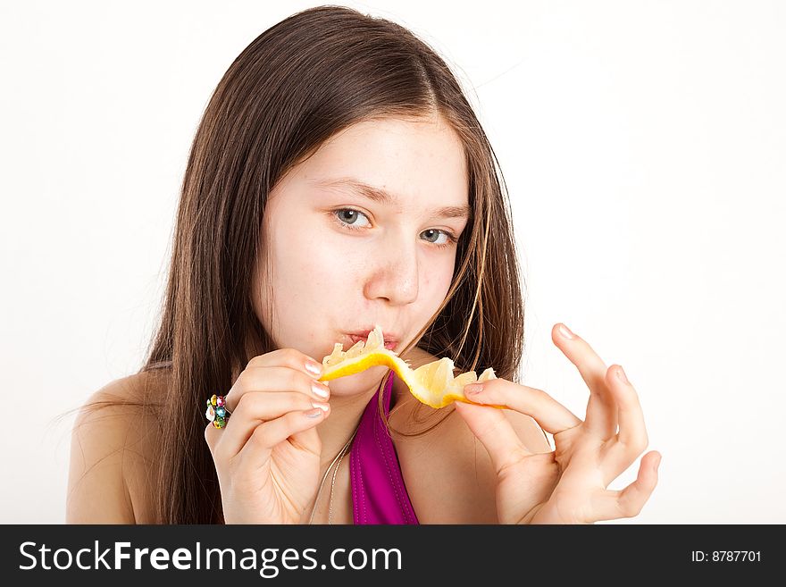 Long hair teen in bikini with piece of lemon. Long hair teen in bikini with piece of lemon