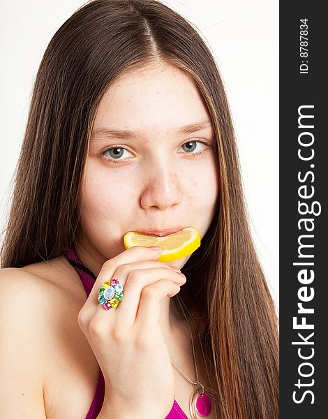 Long hair teen in bikini with piece of lemon. Long hair teen in bikini with piece of lemon