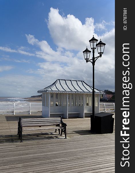 Traditional seating on a beautiful spring day along the seaside pier. Traditional seating on a beautiful spring day along the seaside pier