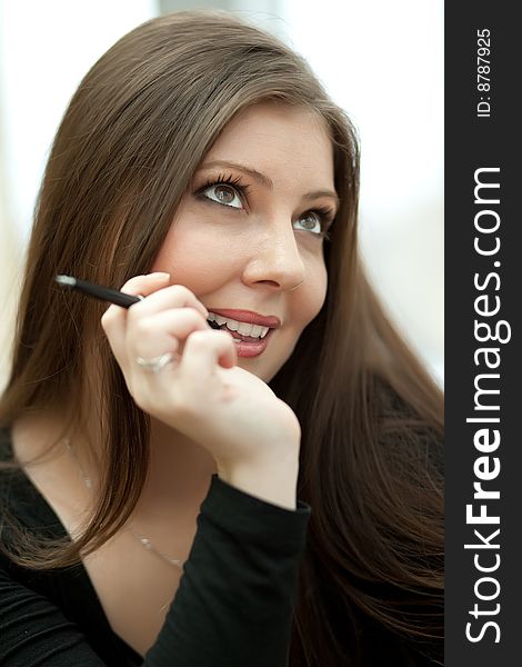 Portrait of a young beautiful businesswoman with pen. Portrait of a young beautiful businesswoman with pen