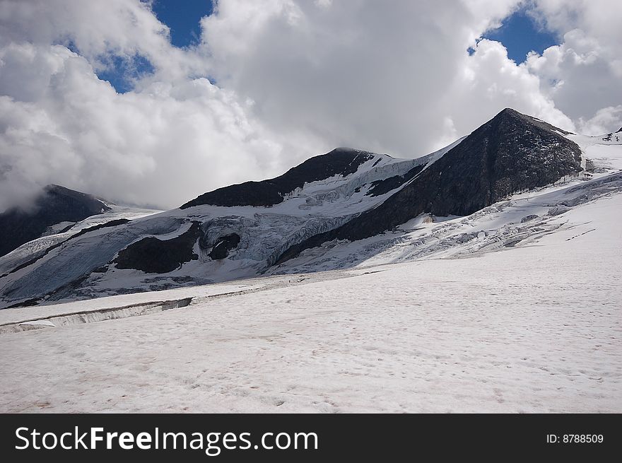 High mountain and glacier with cracks. High mountain and glacier with cracks