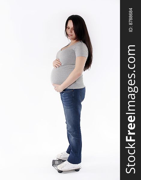 Pregnant woman weighing isolated on white background