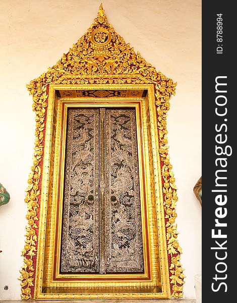 Traditional Thai art door in Buddhist temple, Bangkok, Thailand