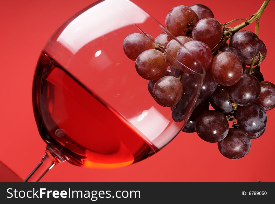 A glass of wine with grapes