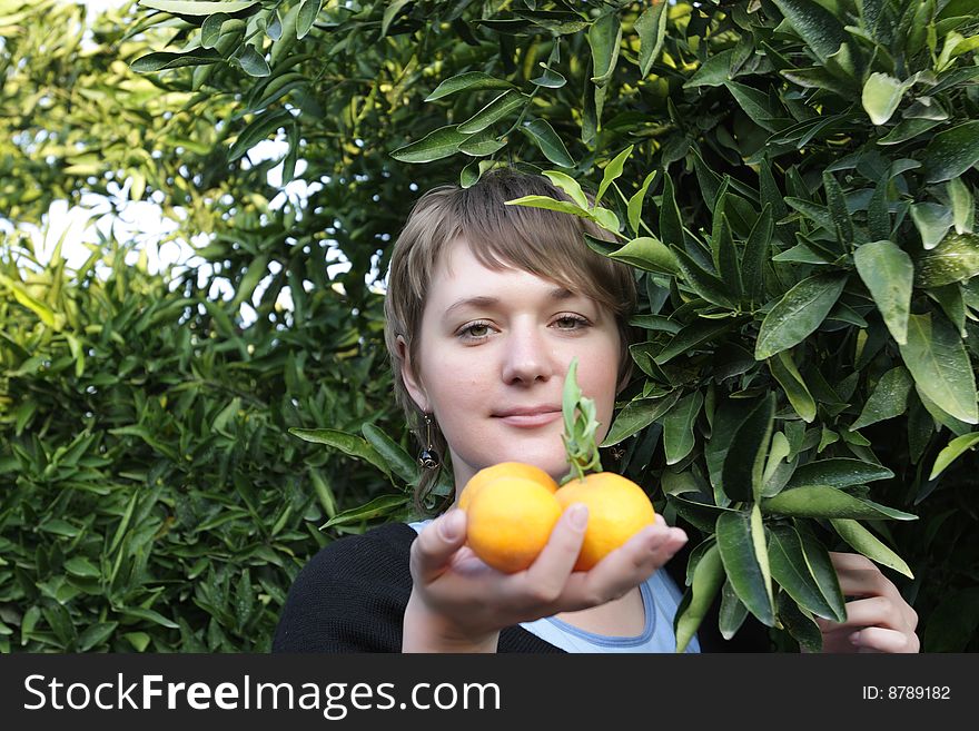 Portrait of woman with orange in a orchard. Portrait of woman with orange in a orchard