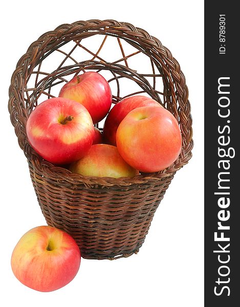 Old vintage wicker basket with red apples. Isolated on a white background.