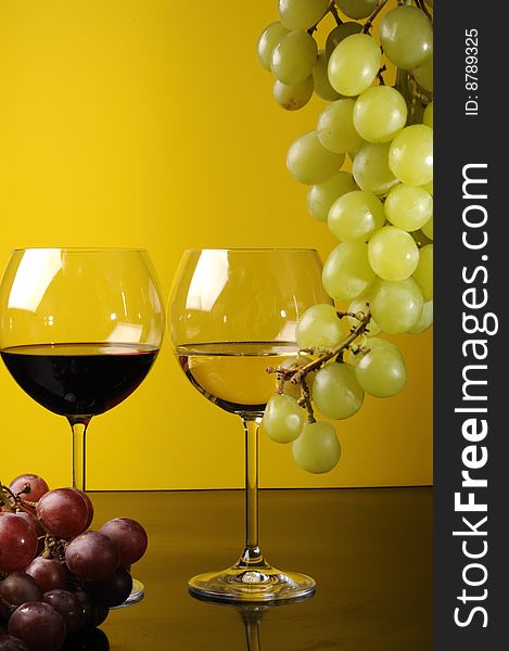 Two glasses of wine with grapes