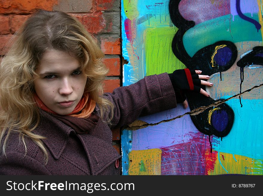 Girl standing near graffiti