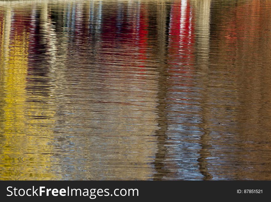 Autumn foliage colors reflected on lake surface. Autumn foliage colors reflected on lake surface.