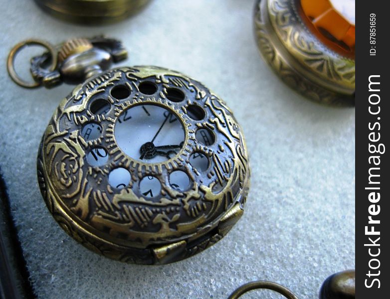 Antique-pocket-watch-with-ornamented-bronze-casing