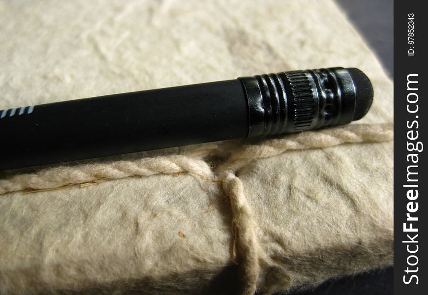 Black-pencil-on-string-binded-notebook
